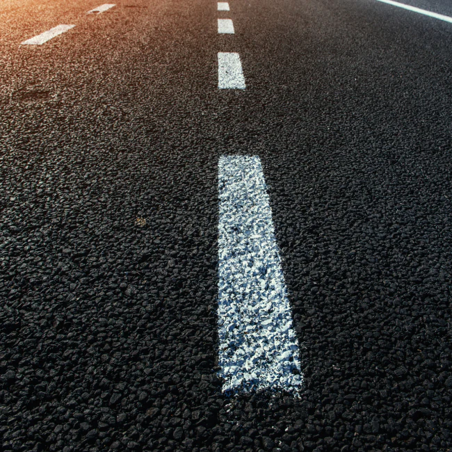 asphalt street with some white signage