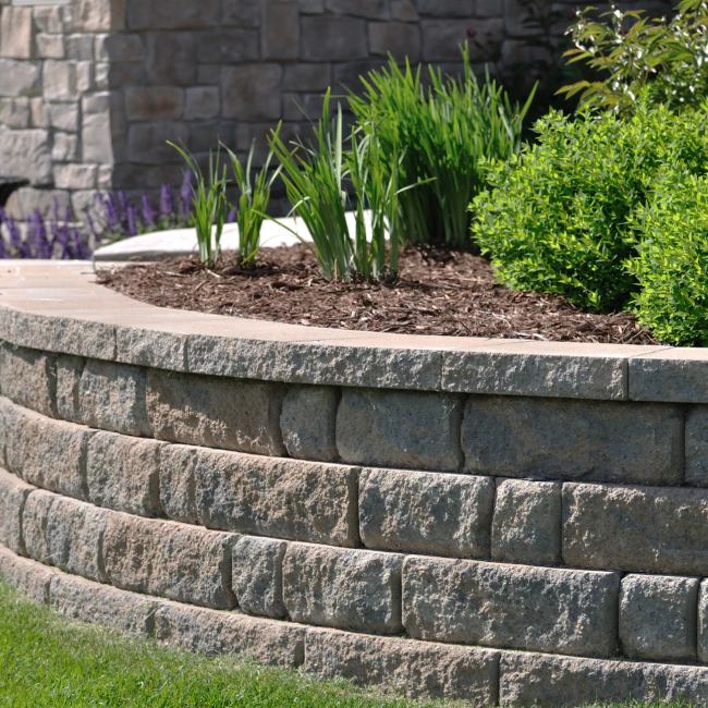 retaining wall with some plants and patio around